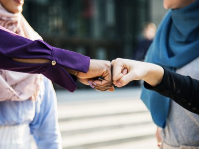 Islamic women friends fist bumps